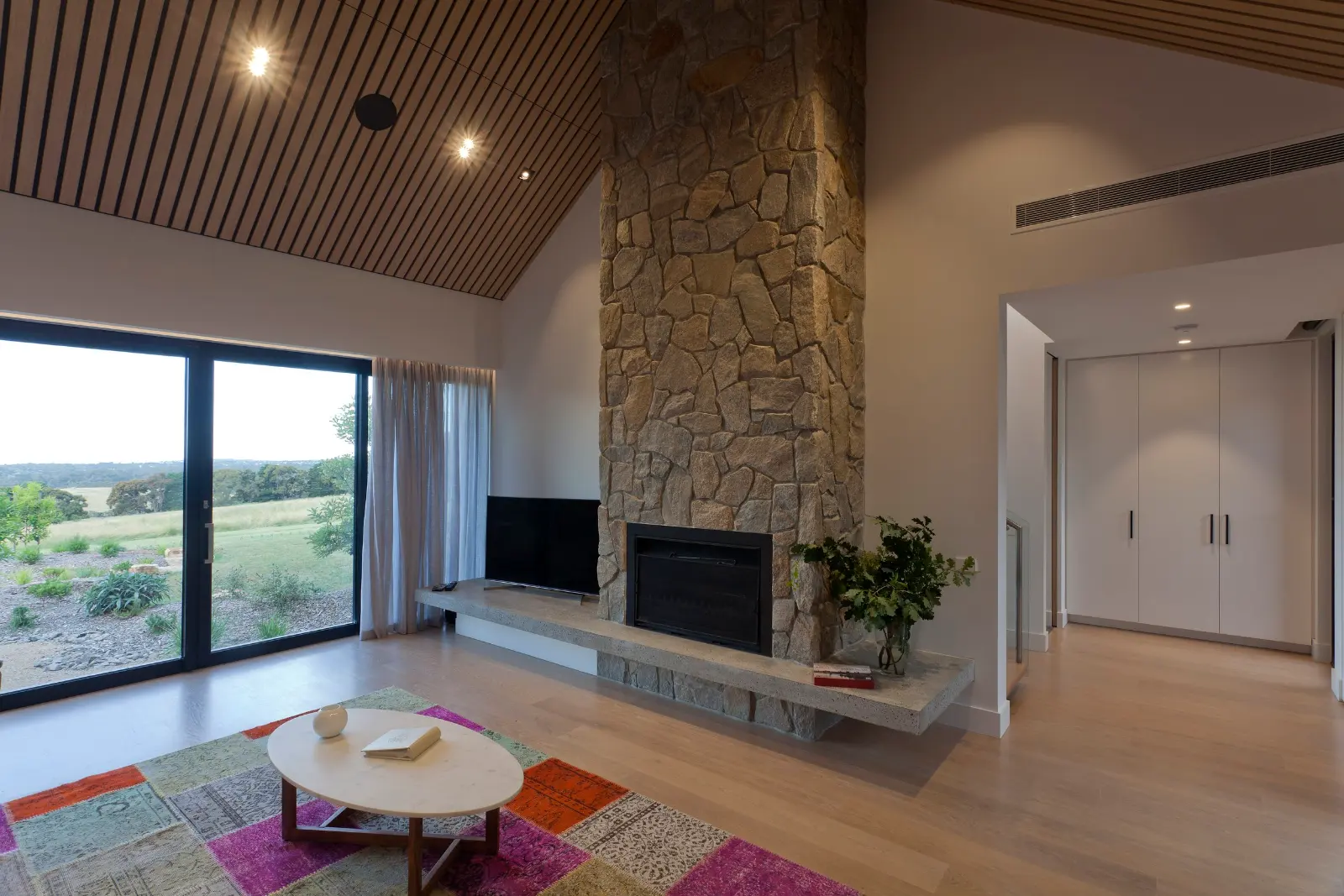 The Range, Red Hill. Living room around the stone fireplace.